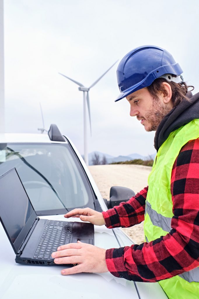 Man working on laptop in car