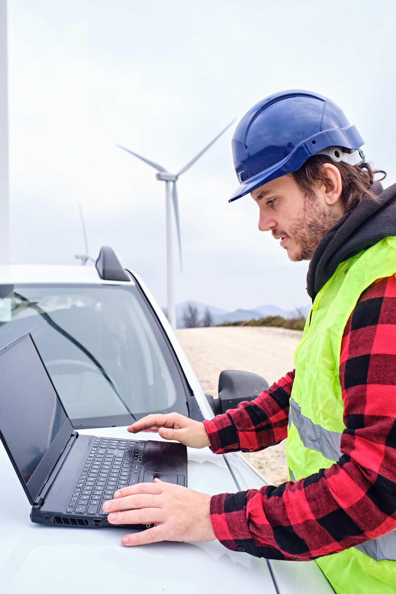 Man working on laptop in car