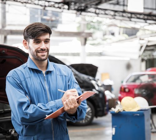Mechanic is taking a car inspection.